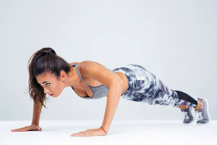 1. Push Ups and Pull Ups! woman doing push ups