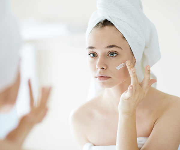 woman using face cream