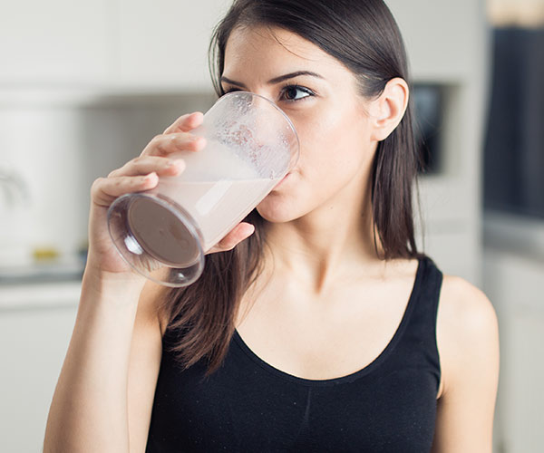 woman drinking protein shake