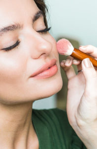 woman applying makeup