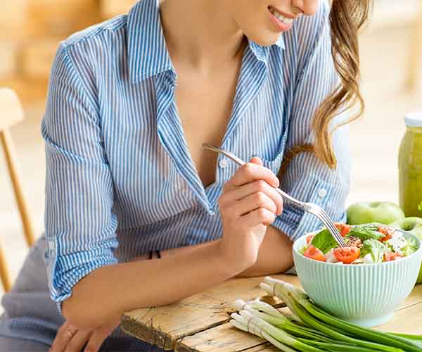 woman eating salad