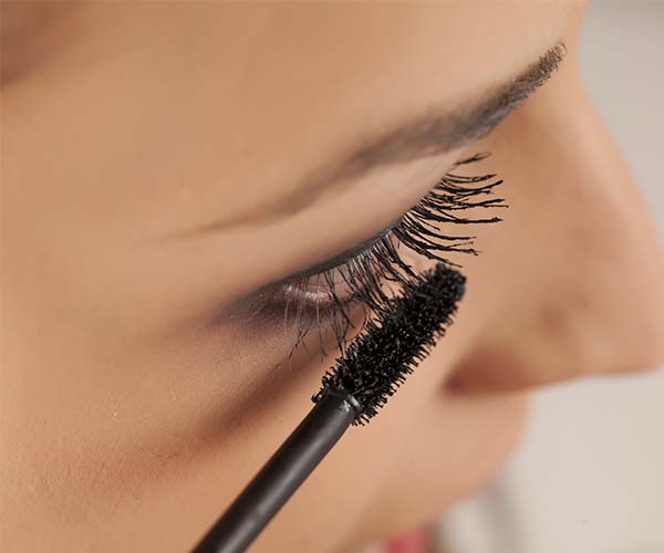 woman applying mascara