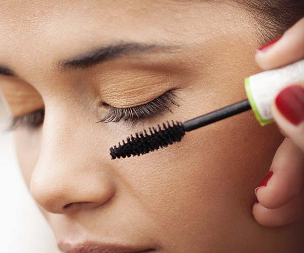 woman applying mascara