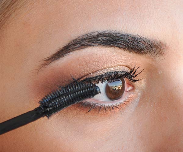 woman applying mascara