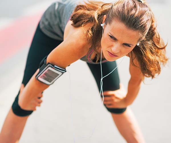 woman resting mid workout