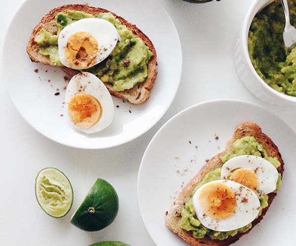 hard boiled eggs and avocado toast on a plate