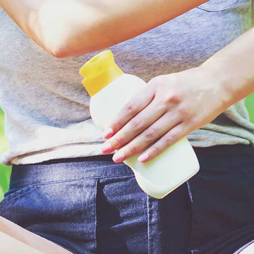 woman holding sunscreen