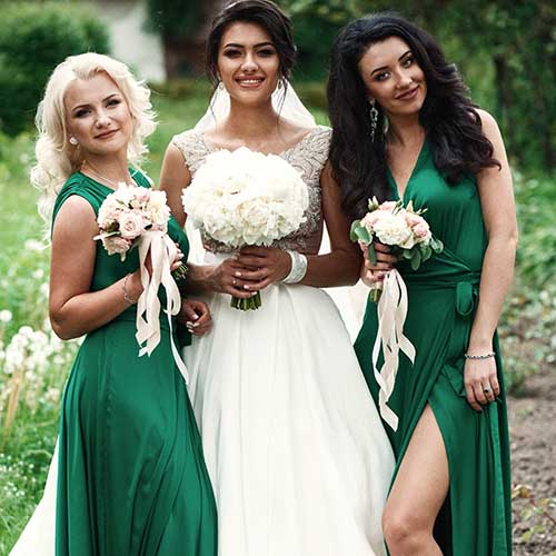 bride posing with bridesmaids outside