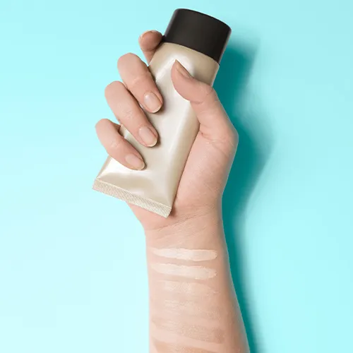 woman holding tinted moisturizer