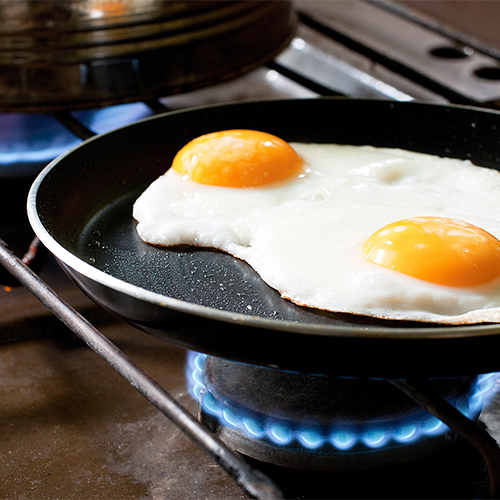 Eggs frying in a skillet.