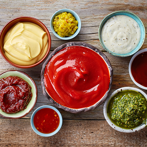 Various condiments and sauces in bowls.