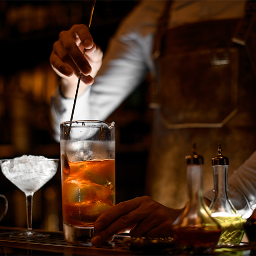 A bartender mixing a drink.