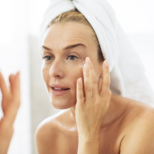 woman applying eye cream