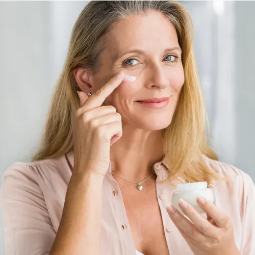 woman putting on lotion