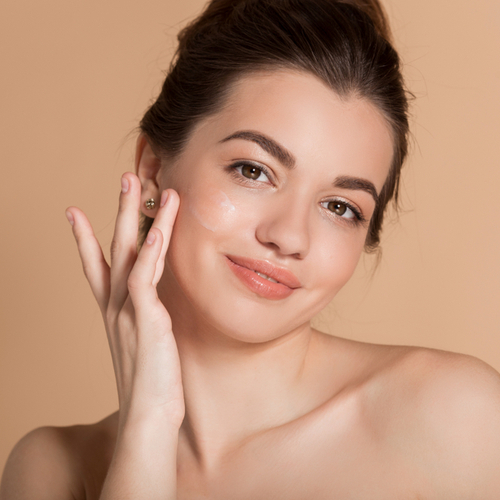 woman applying moisturizer