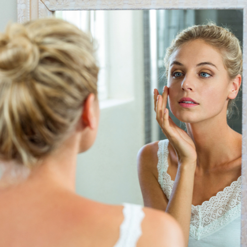 woman looking in mirror