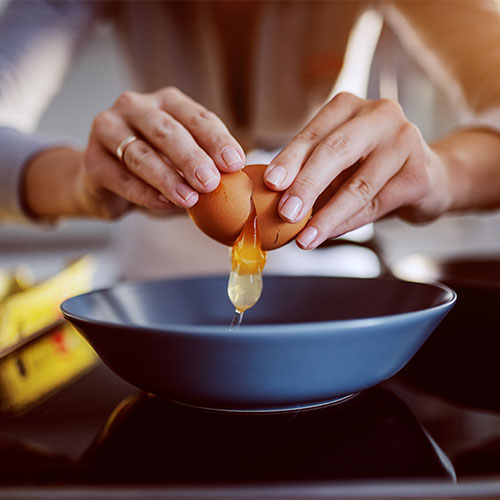 woman cracking egg