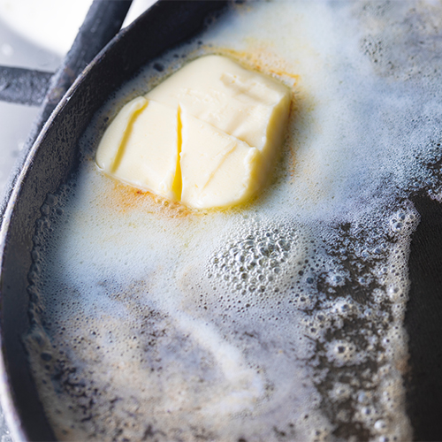 Margarine melting in a pan.