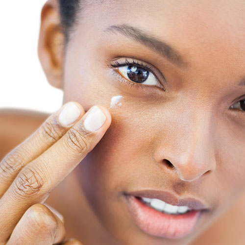 woman applying moisturizer