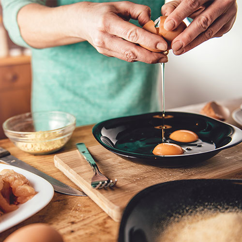 A person cooking eggs.