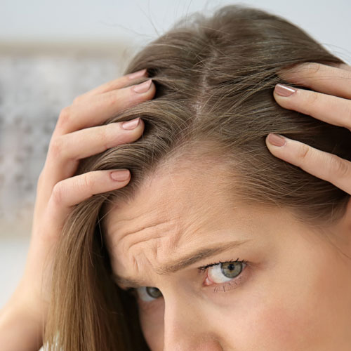 woman looking at hair