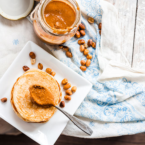 Pancakes with peanut butter on top.