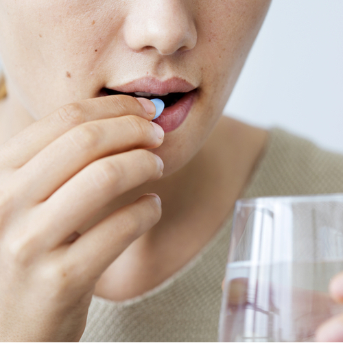 woman taking pill