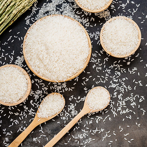 Uncooked white rice in bowls.