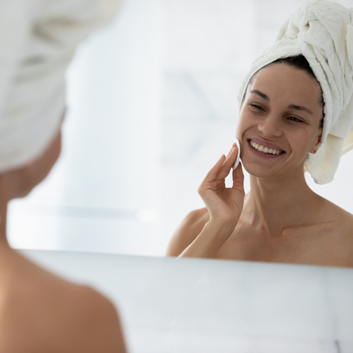 woman looking in mirror