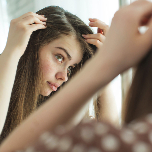 woman checking hair