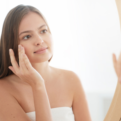 woman looking in mirror