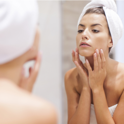 woman looking in mirror