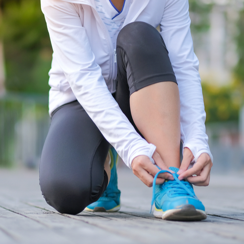 woman tying sneakers