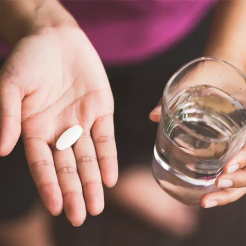 woman taking pill
