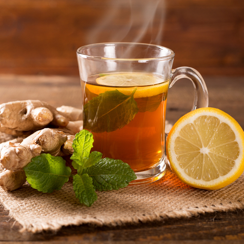 Glass of ginger tea on a table.