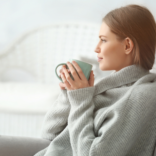 Person sipping on a cup of tea.