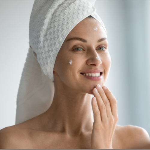 woman applying wrinkle cream