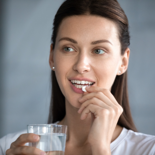 woman taking pill