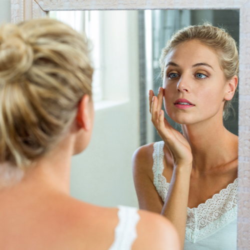 wrinkle free woman looking in mirror