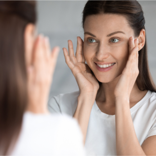 woman looking in mirror