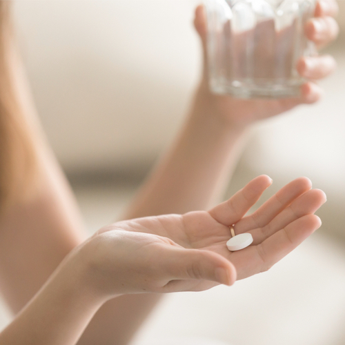 woman taking pill