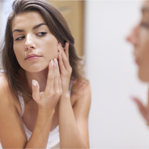 woman looking in mirror