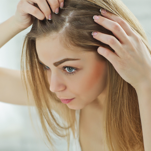 woman looking at hair