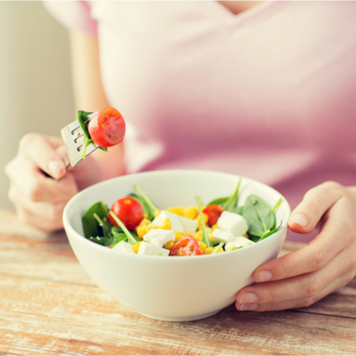 woman eating salad