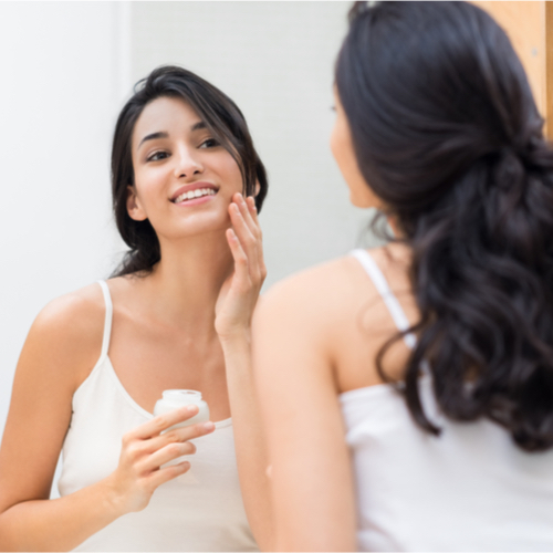 woman looking in mirror