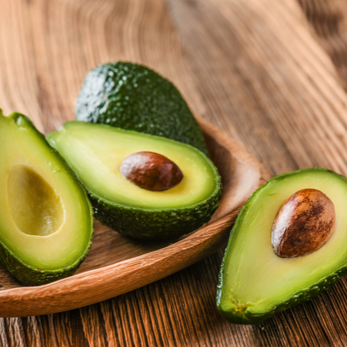 ripe avocados halved with pits inside