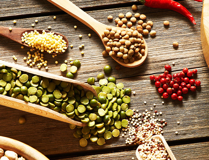 Various legumes and peppers on a table