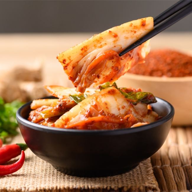 kimchi being eaten with chopsticks