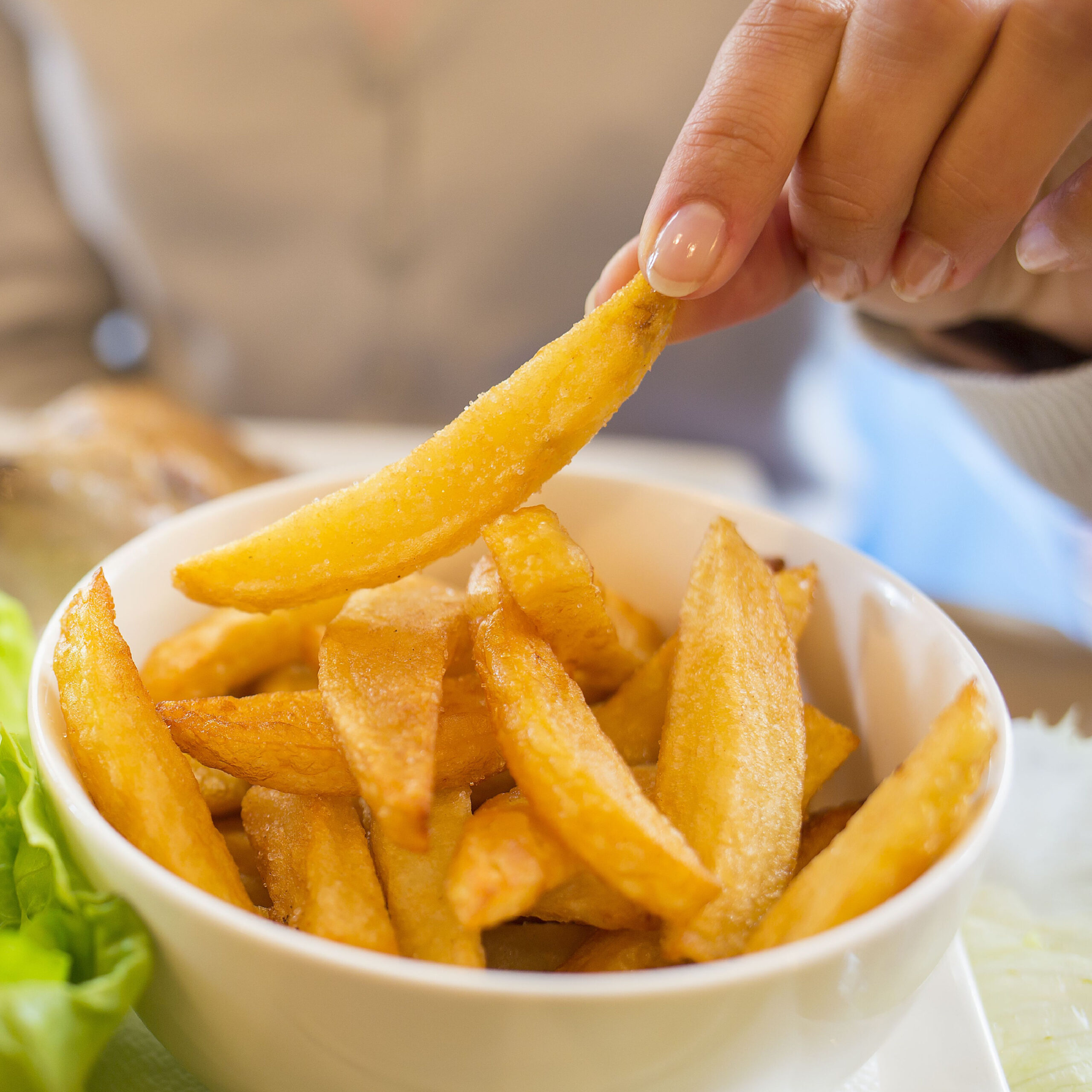 woman eating fries from bowl