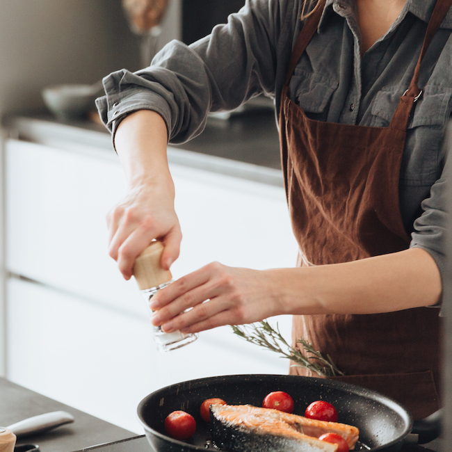 person cooking meal on stove